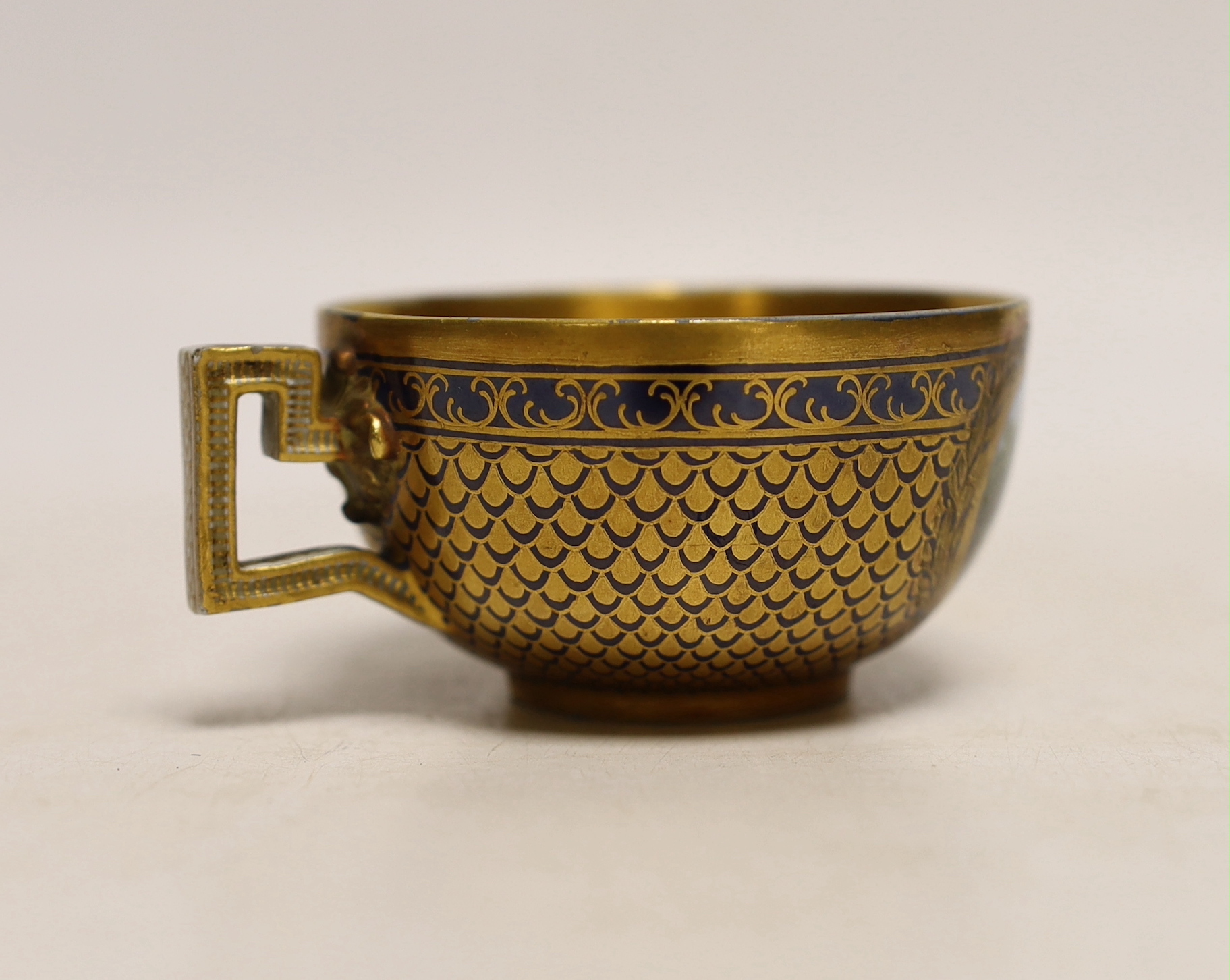 A Meissen Marcolini period cabinet cup, hand painted with figures beneath a tree and gilded interior, crossed sword mark to the base, 8.5cm wide